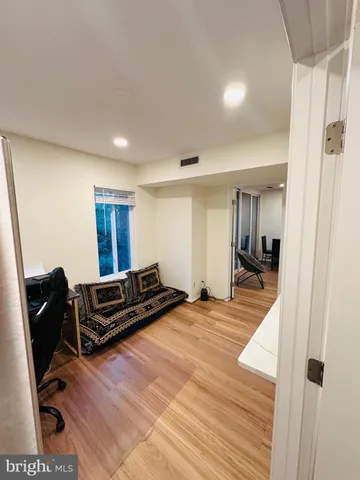 a view of a workspace with furniture and a window