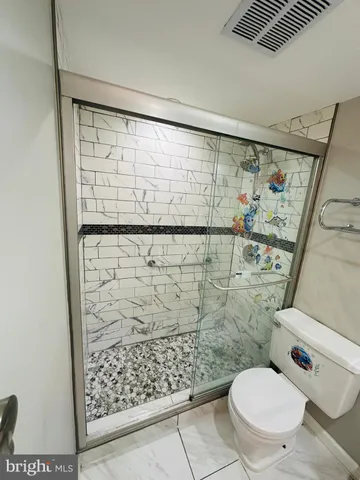 a bathroom with a double vanity sink toilet and shower