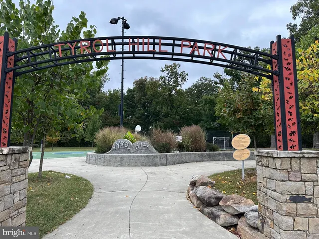 a view of a swimming pool with a yard and seating space
