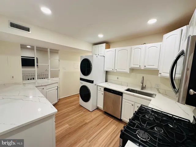 a kitchen with a refrigerator and a stove top oven
