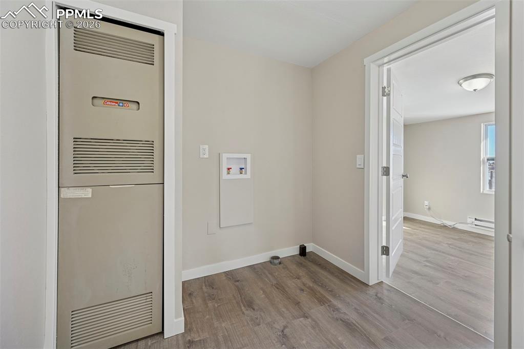 6315 Peerless Farms Road Peyton, CO 80831 - Photo 11 of 49 an empty room with wooden floor mirror and door