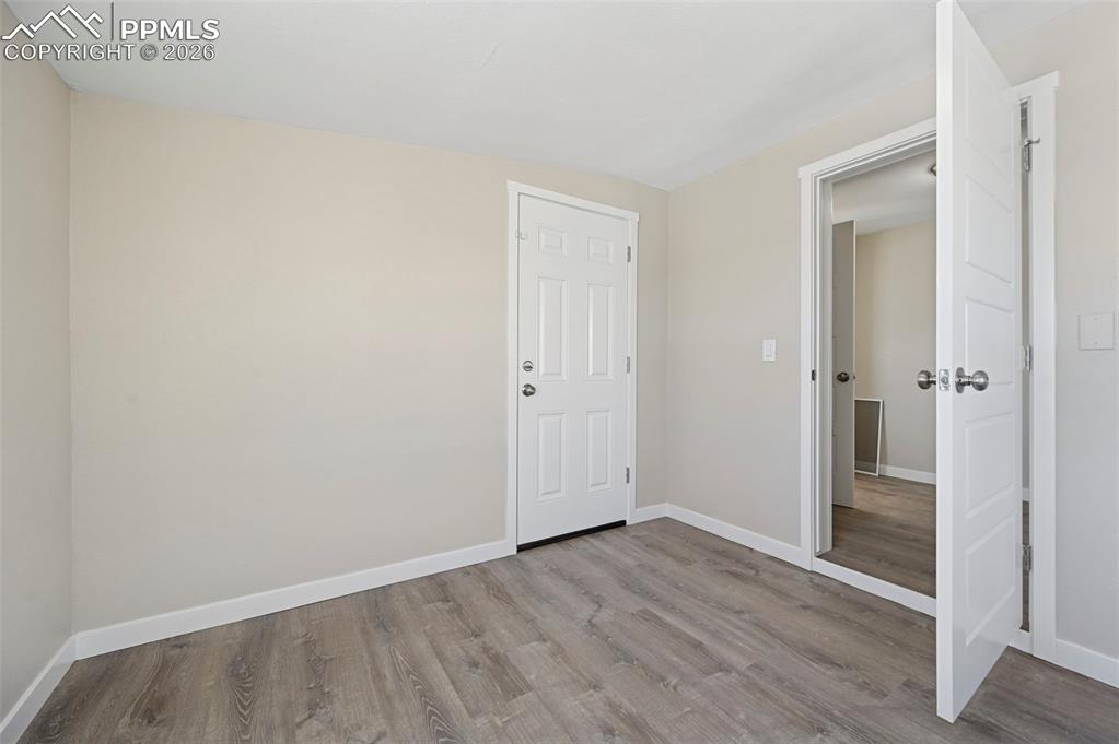 6315 Peerless Farms Road Peyton, CO 80831 - Photo 13 of 49 an empty room with wooden floor