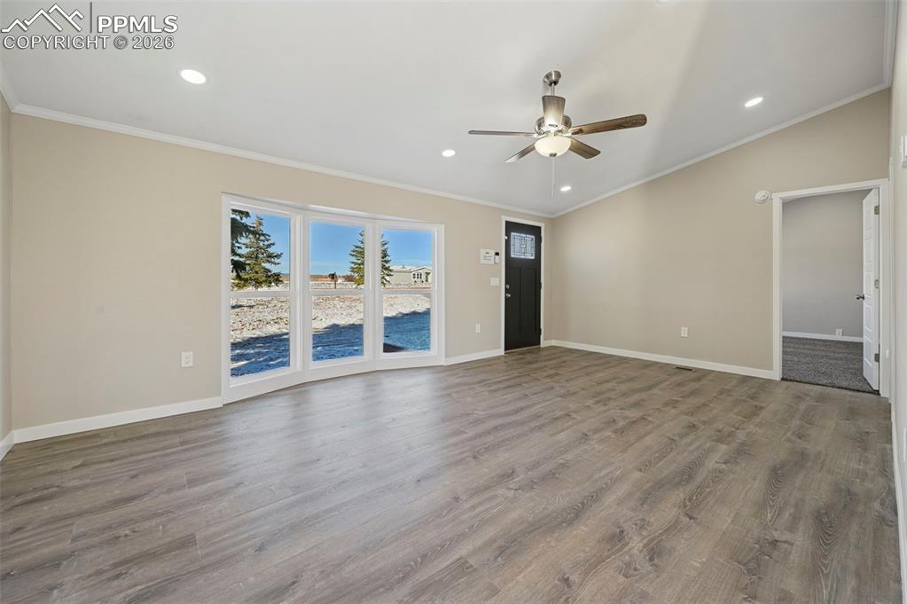 6315 Peerless Farms Road Peyton, CO 80831 - Photo 14 of 49 a view of an empty room with a window and wooden floor