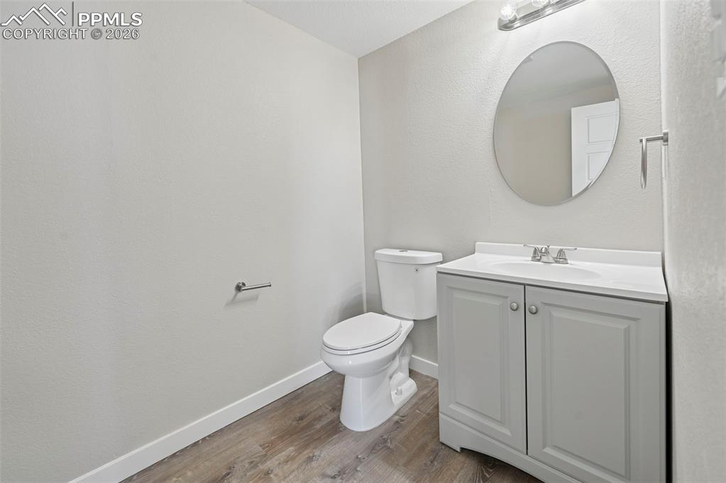 6315 Peerless Farms Road Peyton, CO 80831 - Photo 17 of 49 a bathroom with a toilet sink and mirror