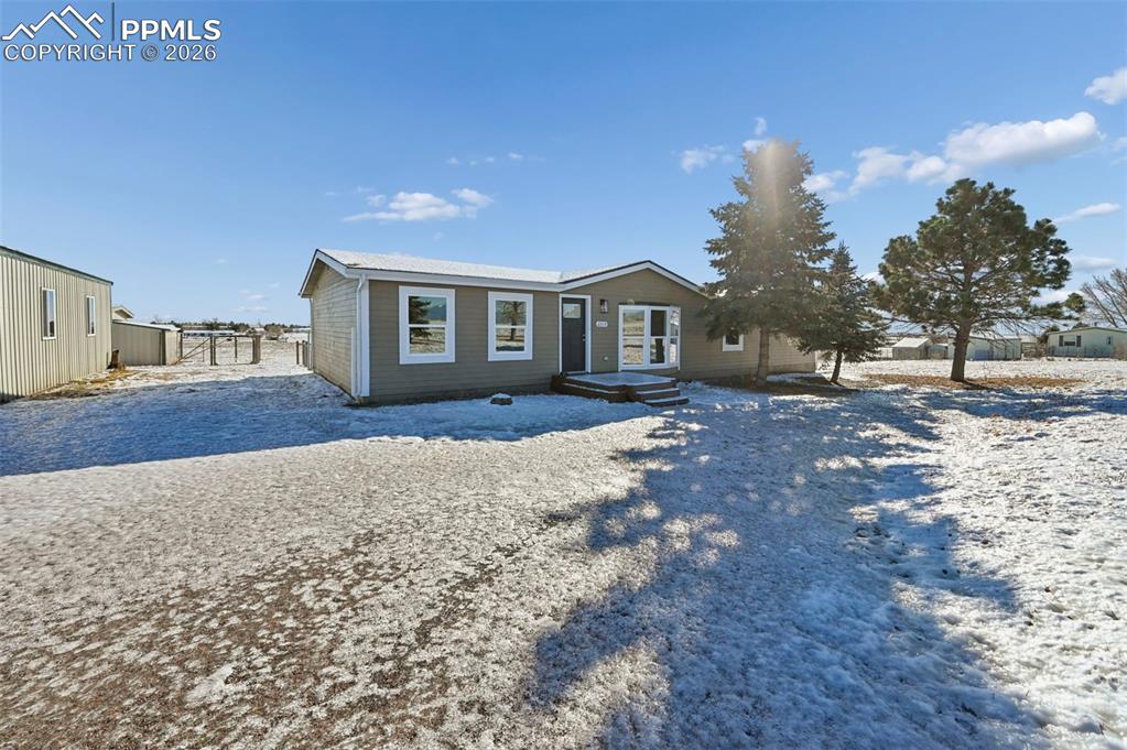 6315 Peerless Farms Road Peyton, CO 80831 - Photo 2 of 49 a front view of a house with a yard and trees