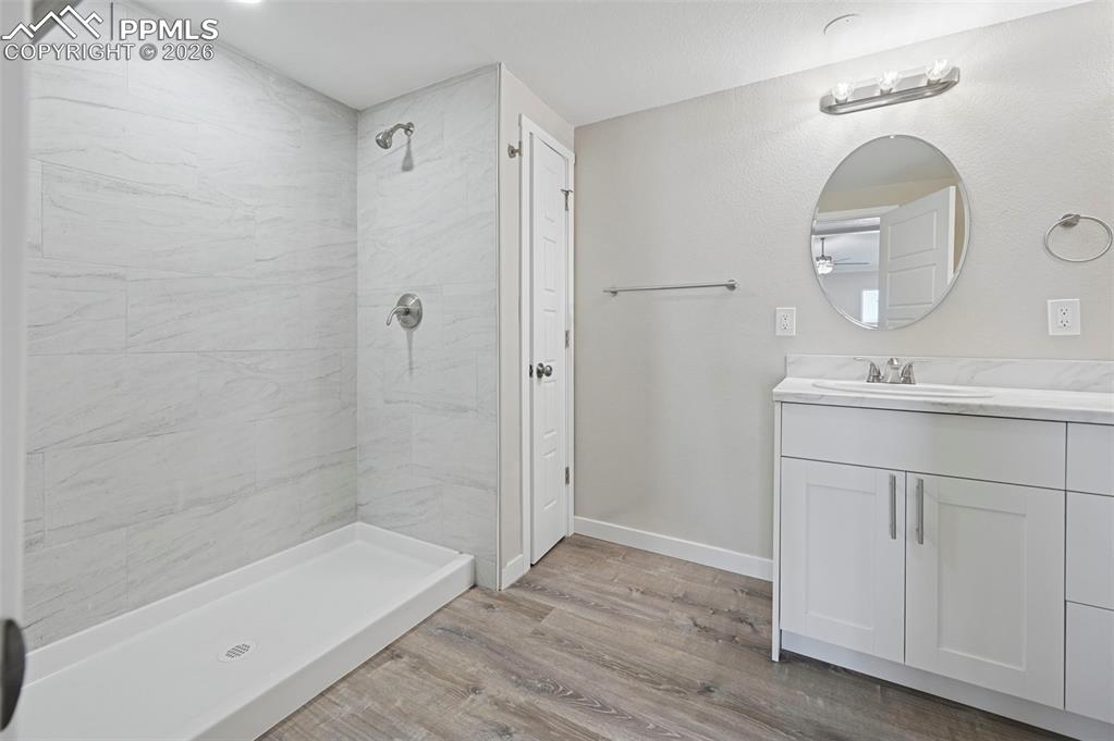 6315 Peerless Farms Road Peyton, CO 80831 - Photo 21 of 49 a bathroom with a sink a toilet and shower