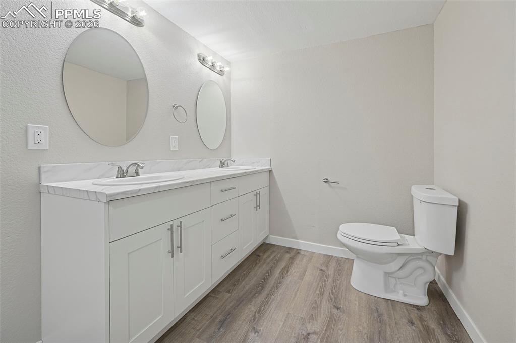 6315 Peerless Farms Road Peyton, CO 80831 - Photo 22 of 49 a bathroom with a toilet sink and mirror
