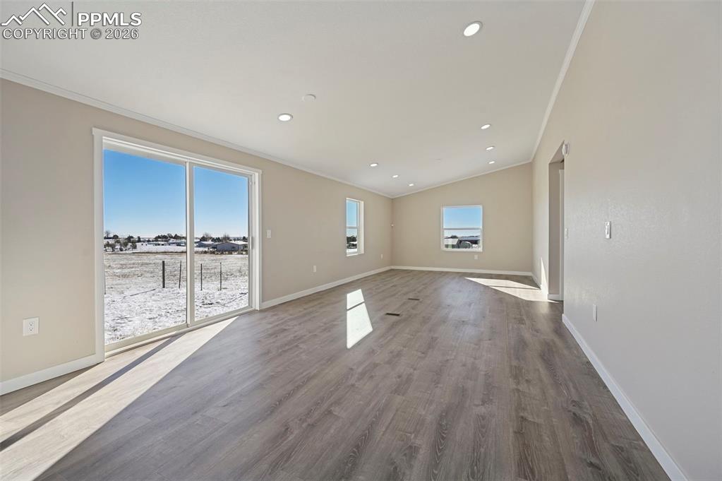 6315 Peerless Farms Road Peyton, CO 80831 - Photo 24 of 49 a view of empty room with wooden floor