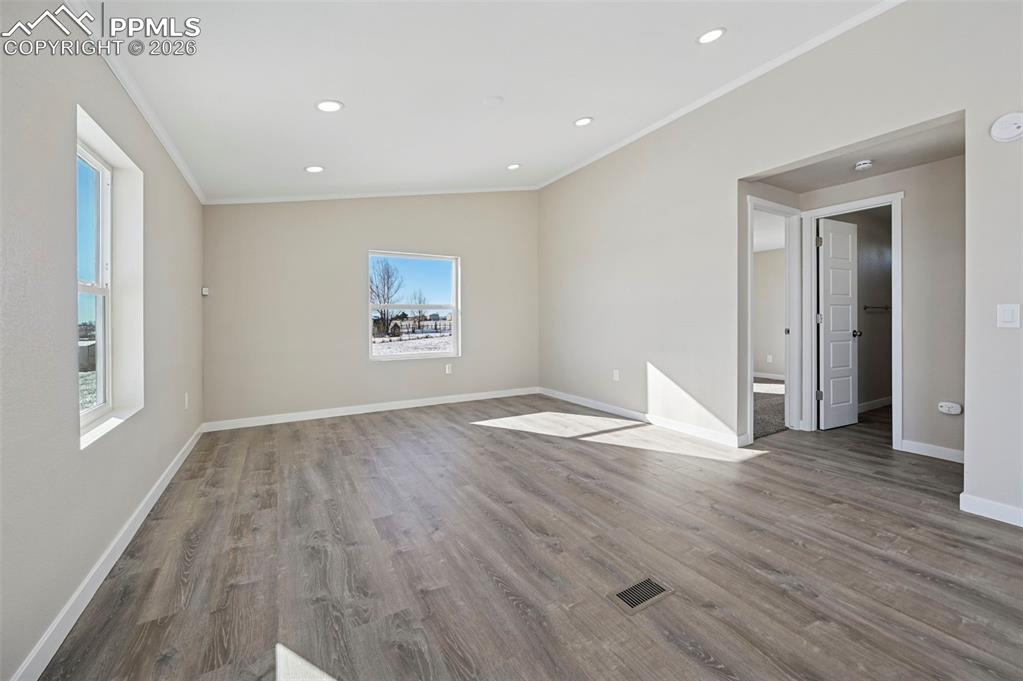 6315 Peerless Farms Road Peyton, CO 80831 - Photo 27 of 49 a view of empty room with wooden floor and window