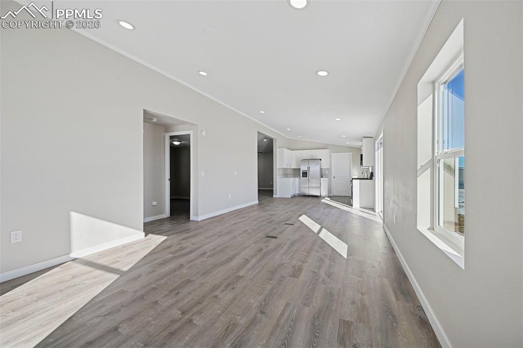 6315 Peerless Farms Road Peyton, CO 80831 - Photo 28 of 49 a view of empty room with wooden floor