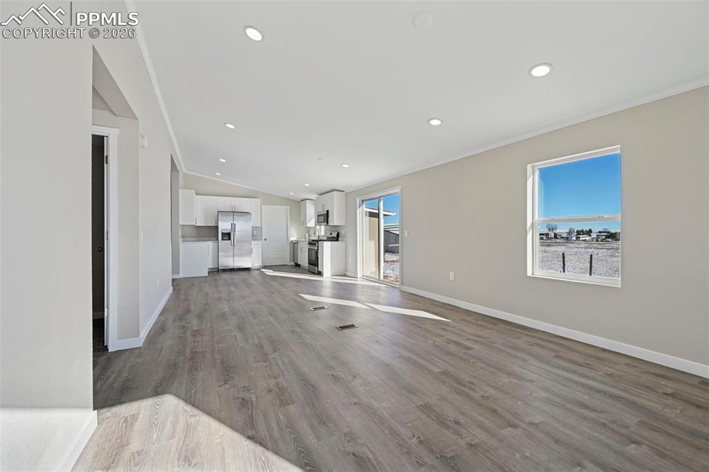 6315 Peerless Farms Road Peyton, CO 80831 - Photo 29 of 49 a view of empty room with wooden floor