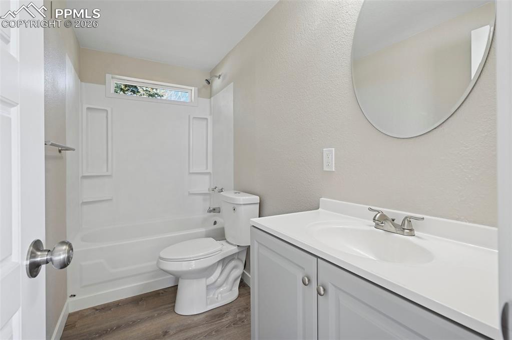 6315 Peerless Farms Road Peyton, CO 80831 - Photo 30 of 49 a bathroom with a sink a toilet and a mirror