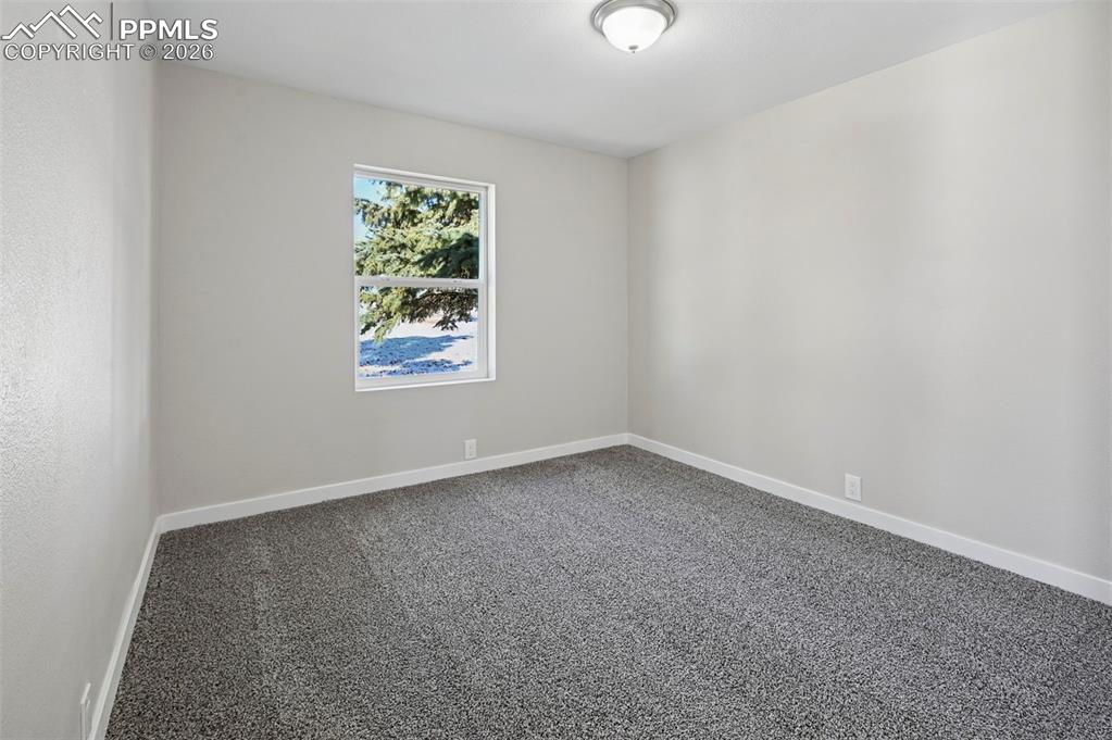6315 Peerless Farms Road Peyton, CO 80831 - Photo 31 of 49 an empty room with a window