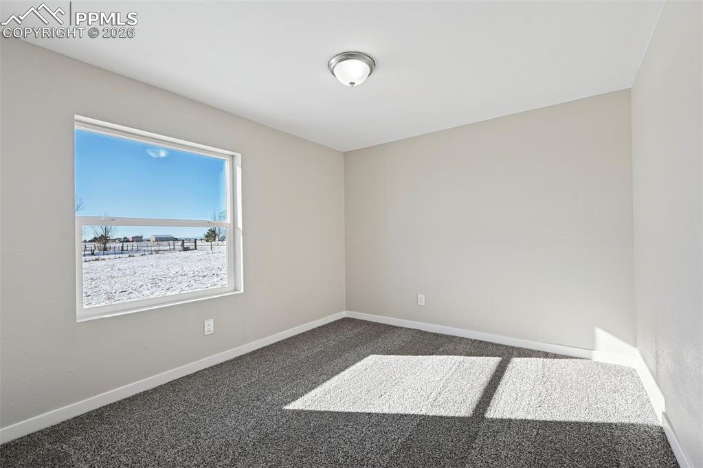 6315 Peerless Farms Road Peyton, CO 80831 - Photo 32 of 49 a view of an empty room with a window