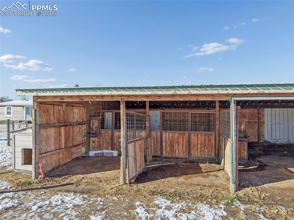 6315 Peerless Farms Road Peyton, CO 80831 - Photo 44 of 49 a view of a house with wooden floor and a fence