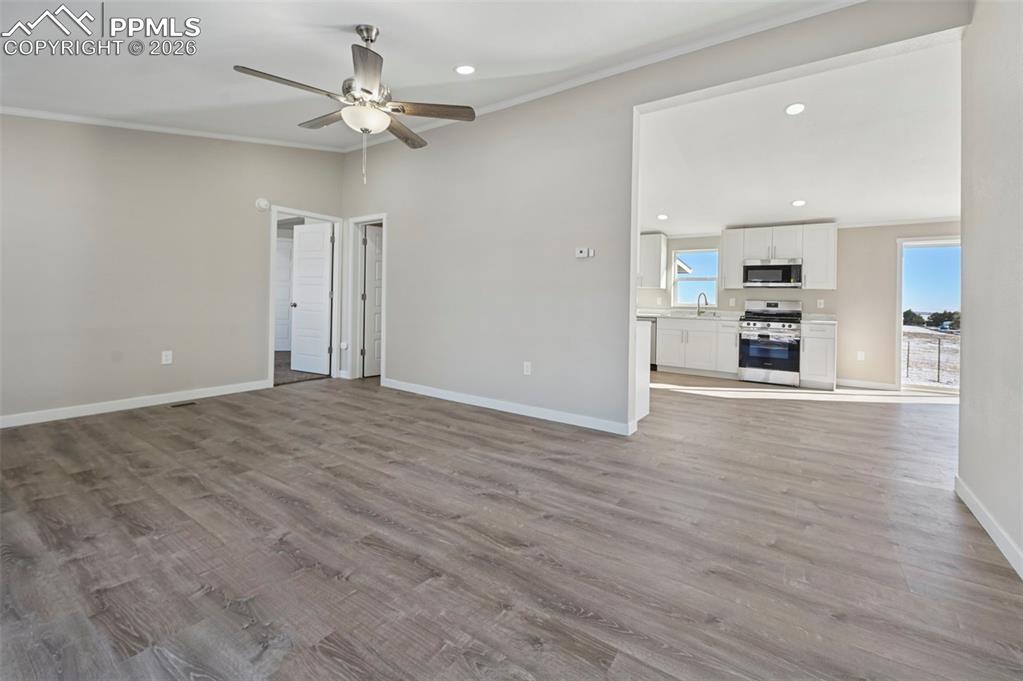 6315 Peerless Farms Road Peyton, CO 80831 - Photo 9 of 49 wooden floor in an empty room with a window