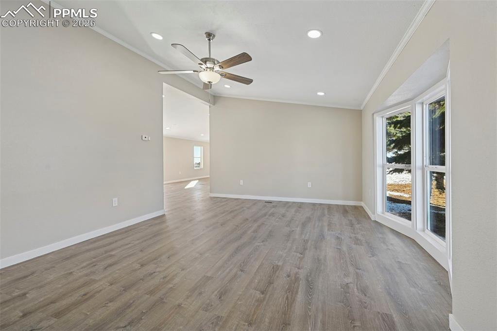 6315 Peerless Farms Road Peyton, CO 80831 - Photo 10 of 49 wooden floor in an empty room with a window