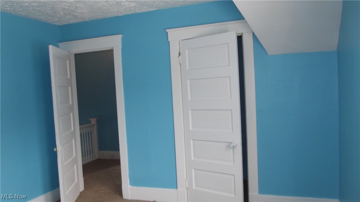 7805 Spafford Road Cleveland, OH 44105 - Photo 14 of 17 Bedroom featuring carpet flooring, a textured ceiling, and baseboards