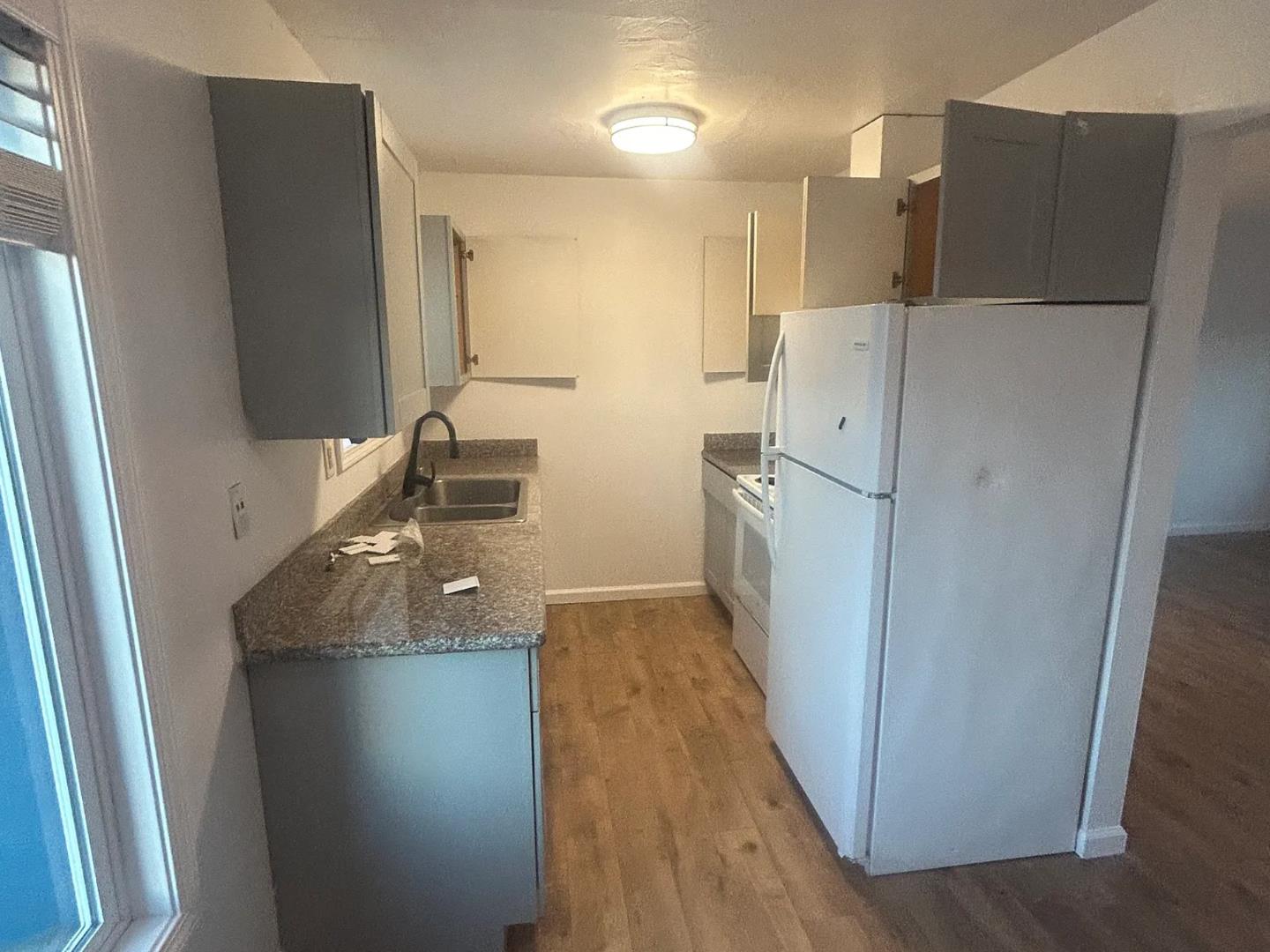 470 Reservation Road Marina, CA 93933 - Photo 5 of 8 a kitchen with refrigerator and door