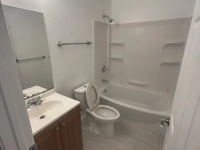 a bathroom with a sink a toilet and a bathtub