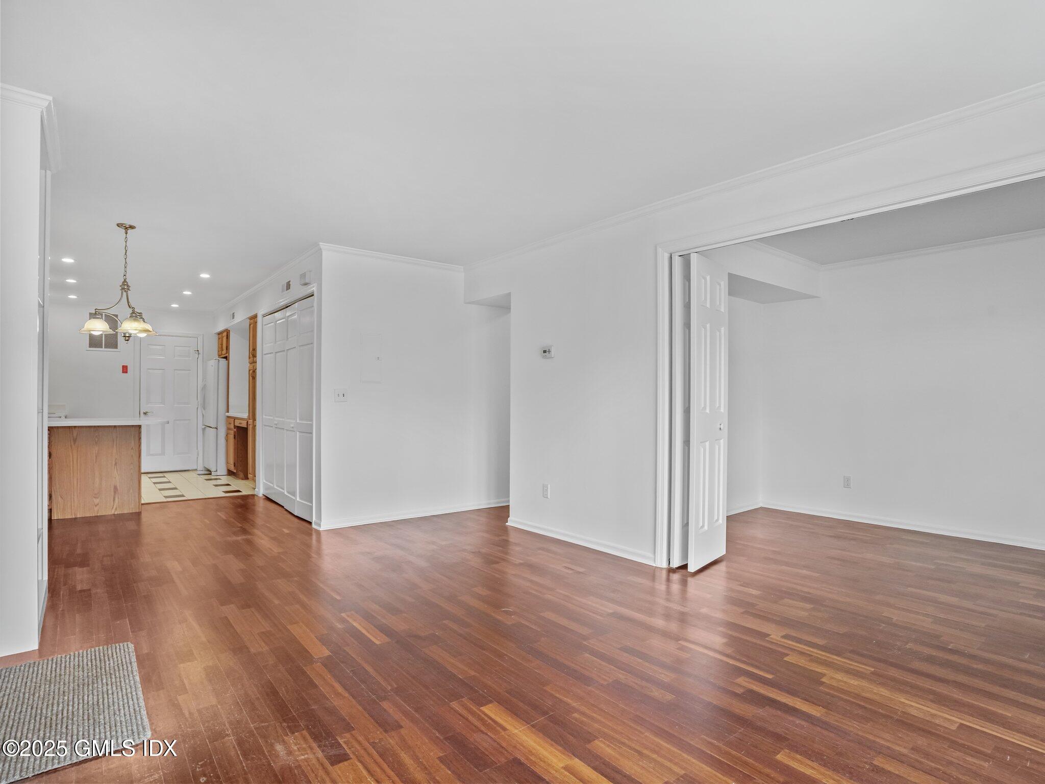 351 Pemberwick Road, Unit 205 Greenwich, CT 06831 - Photo 3 of 12 a view of a hallway with wooden floor