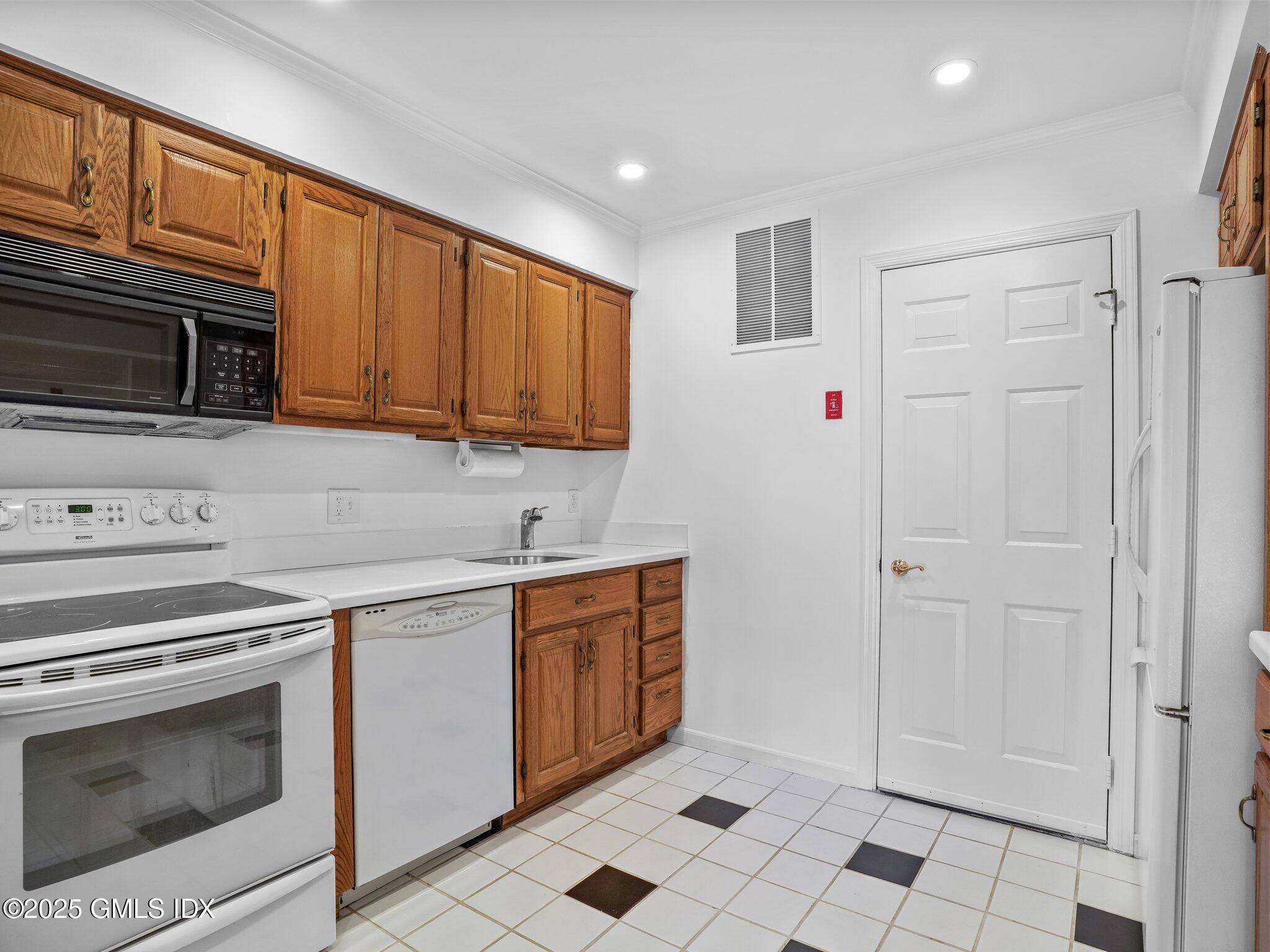 351 Pemberwick Road, Unit 205 Greenwich, CT 06831 - Photo 8 of 12 a kitchen with stainless steel appliances granite countertop a stove a sink and a refrigerator