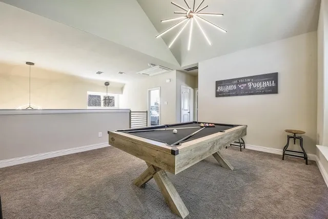 a room with pool table and windows