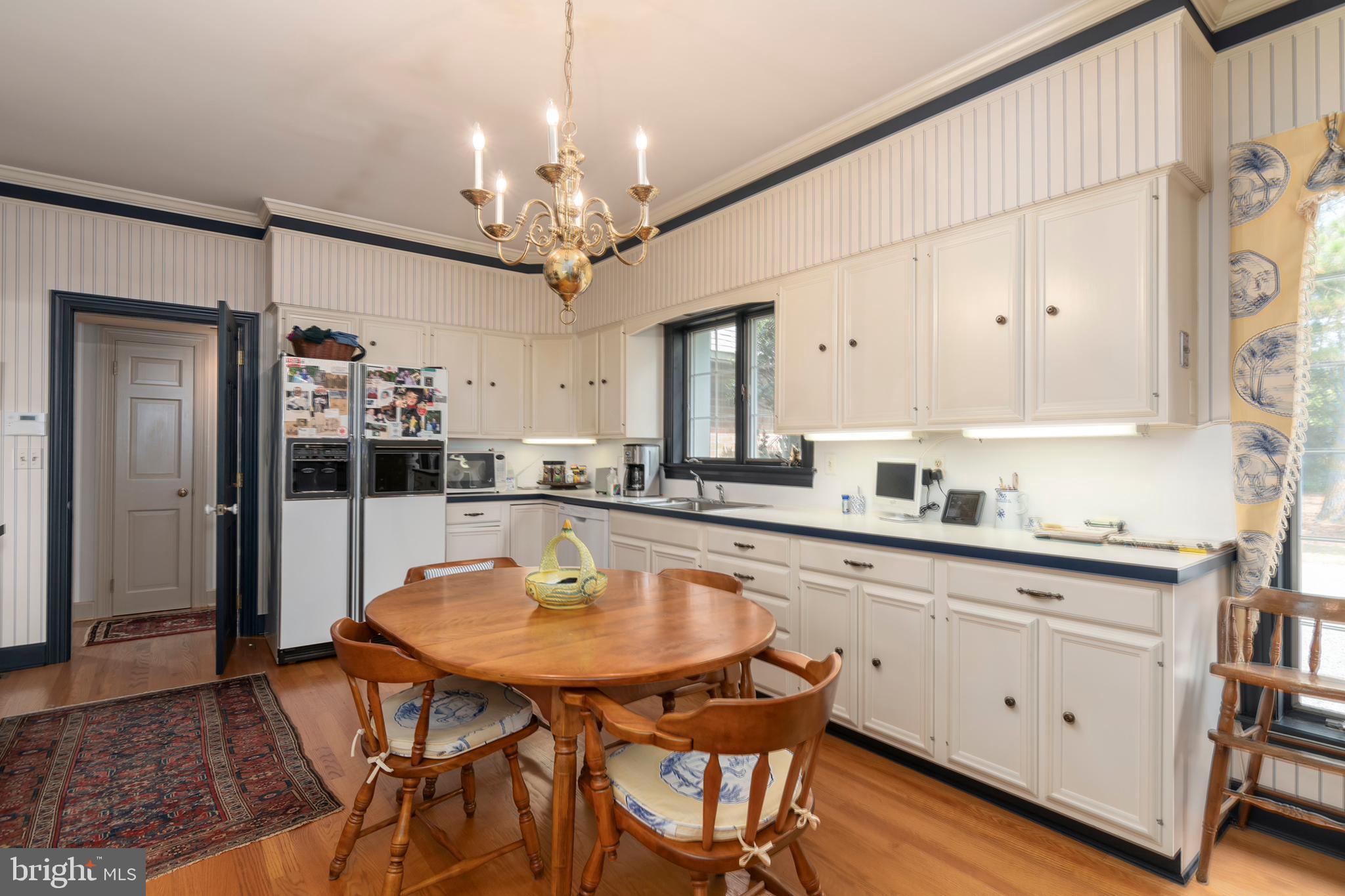 9338 Bantry Road Easton, MD 21601 - Photo 33 of 43 a kitchen with a table chairs and cabinets