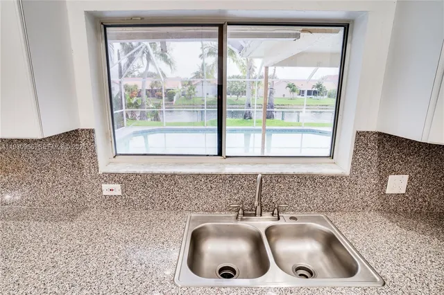 a kitchen with a sink a counter top and a window