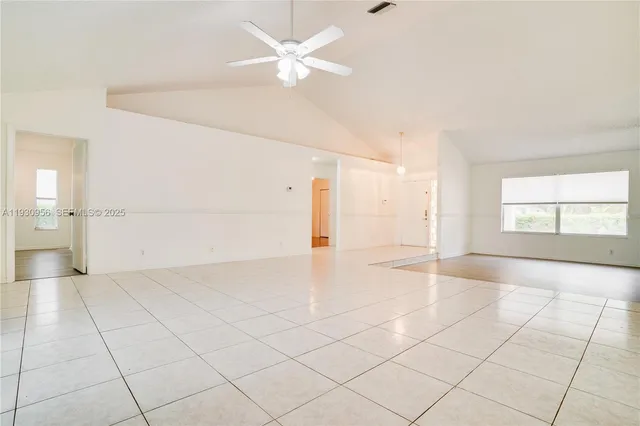 an empty room with entrance and windows