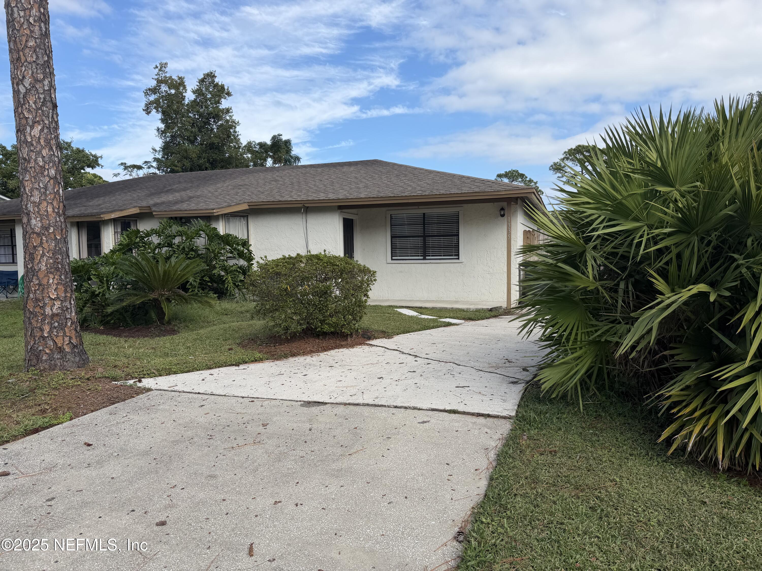 a front view of a house with a yard and a garage