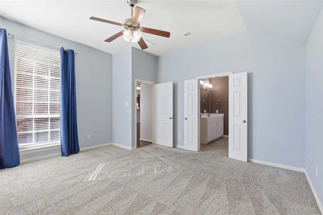 a view of a livingroom with a ceiling fan and window