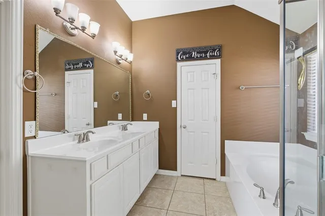 a bathroom with a bathtub and shower