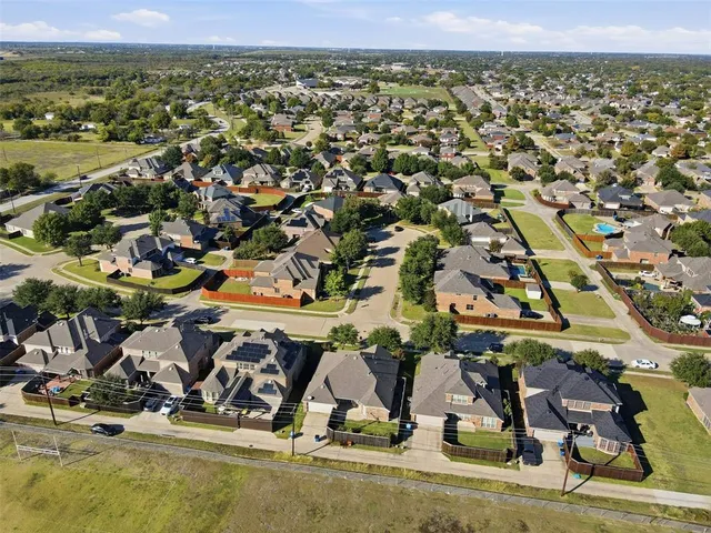 an aerial view of residential houses with outdoor space