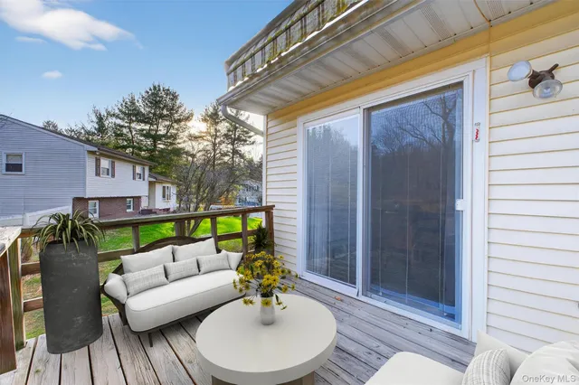 a balcony with furniture and a potted plant