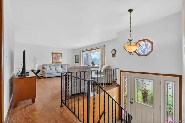 a view of a livingroom with furniture and staircase