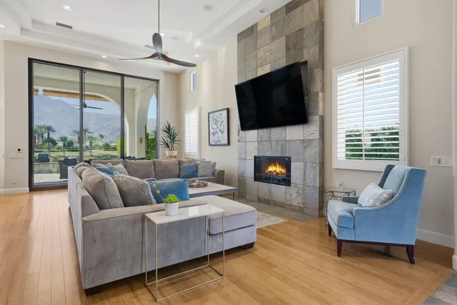 a living room with furniture fireplace and a flat screen tv