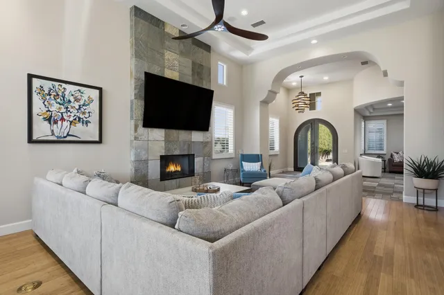 a living room with fireplace furniture and a flat screen tv