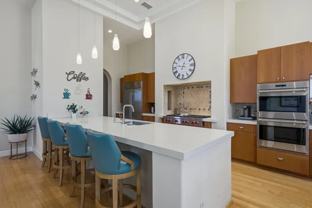 a large kitchen with a table and chairs in it