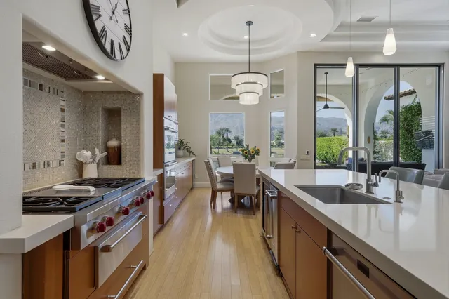 a kitchen with stainless steel appliances a sink stove and cabinets