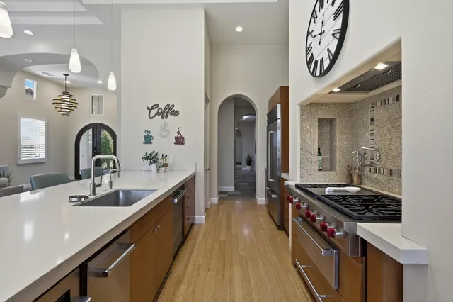 a view of a dining room with furniture wooden floor and chandelier
