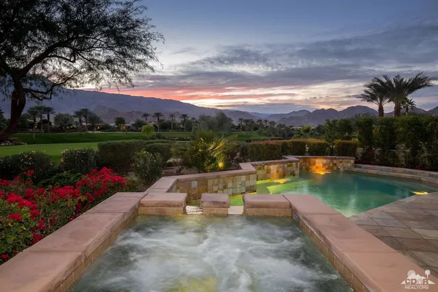a view of a lake with a garden and swimming pool