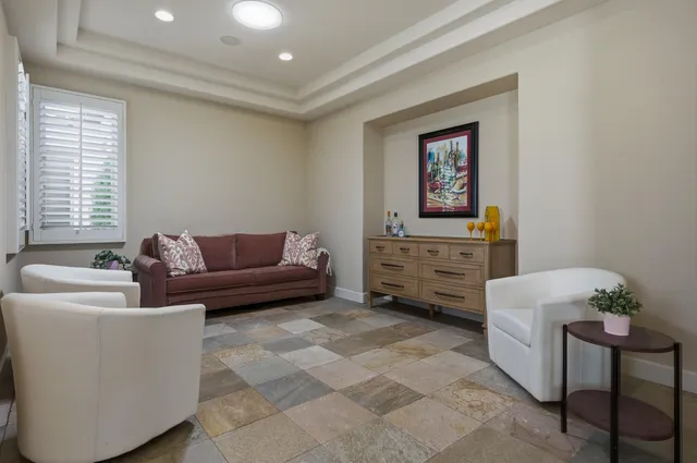a bathroom with a granite countertop sink mirror vanity and toilet