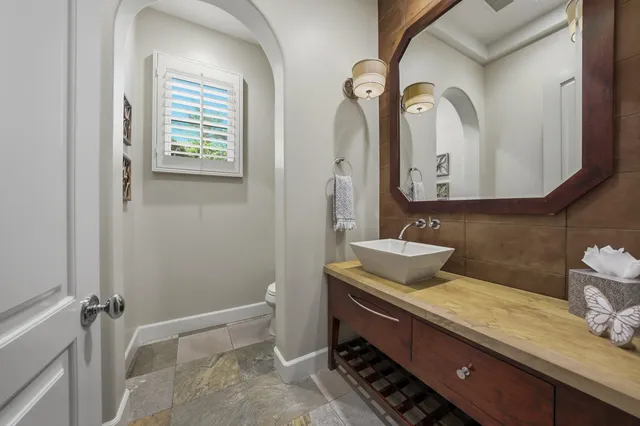 a bedroom with a bed a couch and a view of kitchen