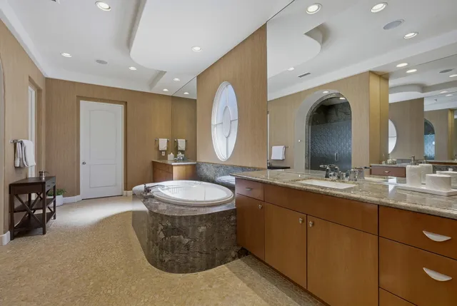 a spacious bathroom with a double vanity sink and a mirror