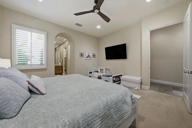 a bathroom with a double vanity sink toilet mirror and shower