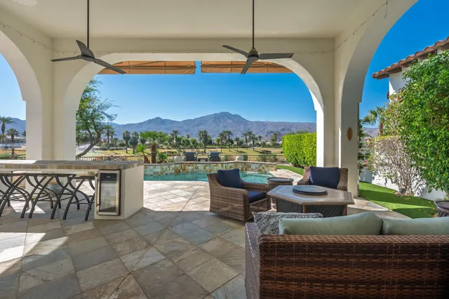 a view of a patio with a table and chairs