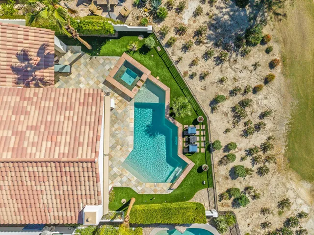 a view of a swimming pool and lounge chairs
