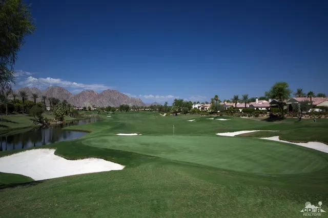 a view of a lake with houses in the background