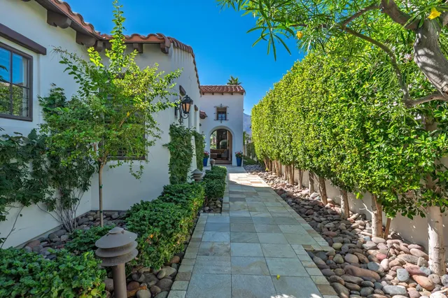 a view of a house with a yard and garden